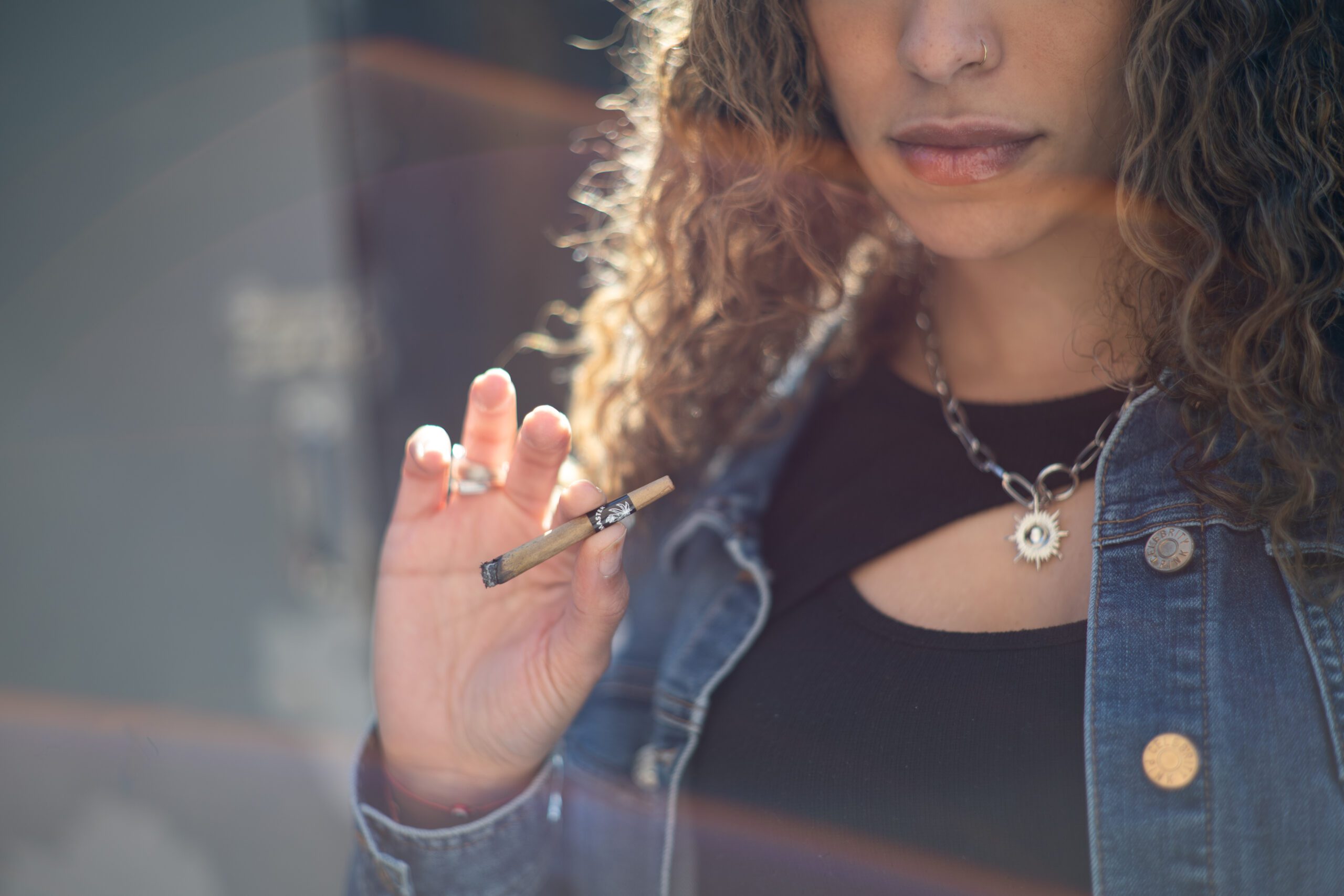 Woman smoking a Budmaster herbal blunt wrap